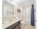 Bright bathroom with a single sink vanity, tiled flooring, and bath-shower at 5156 Oakbourne Ave, Davenport, FL 33837