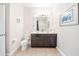 Bathroom with double vanity, a large mirror, and a shower tub with a blue curtain at 5156 Oakbourne Ave, Davenport, FL 33837