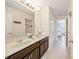 Bright bathroom with double sinks, tiled flooring, and a view to the bedroom at 5156 Oakbourne Ave, Davenport, FL 33837