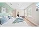 Bright bedroom with two windows, a desk area, and a queen bed dressed in blue and white at 5156 Oakbourne Ave, Davenport, FL 33837