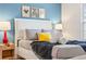 Comfortable queen bed with a padded headboard, stylish lamps, and throw blanket at 5156 Oakbourne Ave, Davenport, FL 33837
