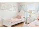 Charming bedroom featuring twin beds, princess decor, and soft natural light at 5156 Oakbourne Ave, Davenport, FL 33837