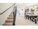Open-concept dining area with a staircase, tile flooring, and modern lighting at 5156 Oakbourne Ave, Davenport, FL 33837