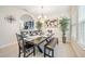 Bright dining area with large table and chairs, modern lighting, and neutral decor at 5156 Oakbourne Ave, Davenport, FL 33837