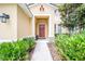 Inviting front entry with a covered porch, manicured plants, and stone accents at 5156 Oakbourne Ave, Davenport, FL 33837