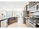 Spacious kitchen with stainless steel appliances, ample counter space, and backyard view at 5156 Oakbourne Ave, Davenport, FL 33837