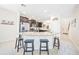 Open kitchen with granite countertops, stainless steel appliances, and dark cabinets at 5156 Oakbourne Ave, Davenport, FL 33837