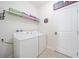 Functional laundry room with washer, dryer, and ample storage space at 5156 Oakbourne Ave, Davenport, FL 33837