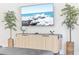 Bright living room with stylish cabinet, decor, and a large TV at 5156 Oakbourne Ave, Davenport, FL 33837