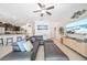 Open-concept living room featuring tile floors, modern furnishings, and a view of the kitchen at 5156 Oakbourne Ave, Davenport, FL 33837