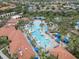 Relax and unwind at the community pool, featuring ample seating and lush palm trees at 5156 Oakbourne Ave, Davenport, FL 33837
