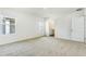 Spacious carpeted bedroom featuring neutral tones, windows, and an ensuite bathroom at 5258 Scrub Mint, Apopka, FL 32712