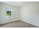 Cozy bedroom with carpet flooring and a bright window overlooking the street at 5258 Scrub Mint, Apopka, FL 32712