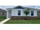 Charming single-story home with stone accents, white trim, and lush green lawn at 5258 Scrub Mint, Apopka, FL 32712