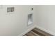 Laundry room hookups with wood-style flooring and neutral walls at 5258 Scrub Mint, Apopka, FL 32712