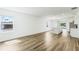 Bright open-concept living area featuring wood-look flooring and natural light from large windows at 5258 Scrub Mint, Apopka, FL 32712