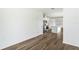 Bright living space featuring wood-look floors connecting kitchen and rooms at 5258 Scrub Mint, Apopka, FL 32712
