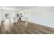 Spacious living area with wood-look floors connecting kitchen and access to outdoor space at 5258 Scrub Mint, Apopka, FL 32712