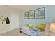 Bright bedroom featuring twin bed and blue accent wall adorned with tennis posters at 5282 Scrub Mint Ln, Apopka, FL 32712