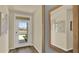 Bright entryway featuring a white door, wood-look floors, and modern decor with a large mirror at 5282 Scrub Mint Ln, Apopka, FL 32712