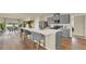 Modern kitchen with an island and bar stools, stainless steel appliances, and ample countertop space at 5282 Scrub Mint Ln, Apopka, FL 32712