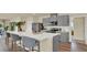 Stylish kitchen featuring a center island with seating, modern appliances, and sleek gray cabinets at 5282 Scrub Mint Ln, Apopka, FL 32712