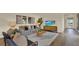 Bright living room with comfortable seating, TV, and a view into the entryway and hallway beyond at 5282 Scrub Mint Ln, Apopka, FL 32712