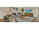 Cozy living room featuring a comfortable couch, modern TV, and stylish decorations on light wood floors at 5282 Scrub Mint Ln, Apopka, FL 32712