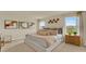 Cozy bedroom with king bed, stylish wall art, and ample natural light showcasing the relaxing ambiance at 5282 Scrub Mint Ln, Apopka, FL 32712