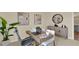 Cozy home office with modern desk, ergonomic chair, decorative artwork, and storage cabinet at 5282 Scrub Mint Ln, Apopka, FL 32712