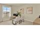 Well-lit home office with a glass desk, two chairs, carpet flooring and a large window overlooking the street at 5282 Scrub Mint Ln, Apopka, FL 32712