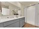 Bathroom featuring double sinks, a large mirror, and a walk-in shower, perfect for a modern home at 5290 Scrub Mint Ln, Apopka, FL 32712