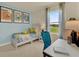 Cozy bedroom with tennis-themed decor, a desk, and a window overlooking a lush green landscape at 5290 Scrub Mint Ln, Apopka, FL 32712