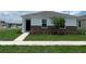 Charming single-Gathering home featuring stone accents, a well-manicured lawn, and a neatly landscaped front yard at 5290 Scrub Mint Ln, Apopka, FL 32712