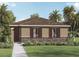 Charming single-story home with brown shutters, stone accents, and lush landscaping and palm trees at 5290 Scrub Mint Ln, Apopka, FL 32712