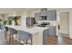Modern kitchen with gray cabinets, stainless steel appliances, a white countertop, and breakfast bar at 5290 Scrub Mint Ln, Apopka, FL 32712