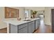 Spacious kitchen island with gray cabinets, white countertops, and view into the dining area at 5290 Scrub Mint Ln, Apopka, FL 32712
