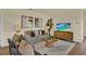 Comfortable living room with a gray sofa, flat screen TV, and contemporary decor at 5290 Scrub Mint Ln, Apopka, FL 32712