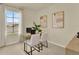 Well-lit office space with a modern desk, two white chairs, and a view outside at 5290 Scrub Mint Ln, Apopka, FL 32712