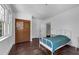Bright bedroom with hardwood floors, large windows, a simple white bed frame, and a spacious closet at 604 Cherokee Dr, Orlando, FL 32801