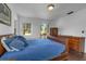 Cozy bedroom with wood floors and a comfortable bed with blue bedding at 604 Cherokee Dr, Orlando, FL 32801