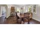 Bright dining room with hardwood floors, a large table, and decorative shelving for an elegant dining experience at 604 Cherokee Dr, Orlando, FL 32801