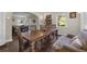 Bright dining room with hardwood floors, large wood table and comfortable sofa seating at 604 Cherokee Dr, Orlando, FL 32801