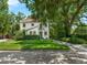 Charming two-story home with a red tile roof, lush landscaping, and a well-manicured lawn at 604 Cherokee Dr, Orlando, FL 32801
