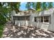 Charming stucco home featuring a red tile roof, screened porch, and a paved driveway surrounded by lush greenery at 604 Cherokee Dr, Orlando, FL 32801