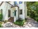 A stucco home boasts a quaint balcony, arched windows, and a decorative water fountain at the entrance at 604 Cherokee Dr, Orlando, FL 32801
