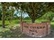 Scenic view of Lake Cherokee Park with a brick sign surrounded by lush greenery and mature trees at 604 Cherokee Dr, Orlando, FL 32801