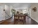 Bright living room featuring hardwood floors, fireplace, vintage furniture and access to the dining room at 604 Cherokee Dr, Orlando, FL 32801