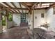 Covered patio space with brick flooring, wooden table and chairs, and tranquil garden views at 604 Cherokee Dr, Orlando, FL 32801