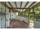 Covered patio area featuring brick flooring, wooden beams, a ceiling fan and comfortable bench seating at 604 Cherokee Dr, Orlando, FL 32801